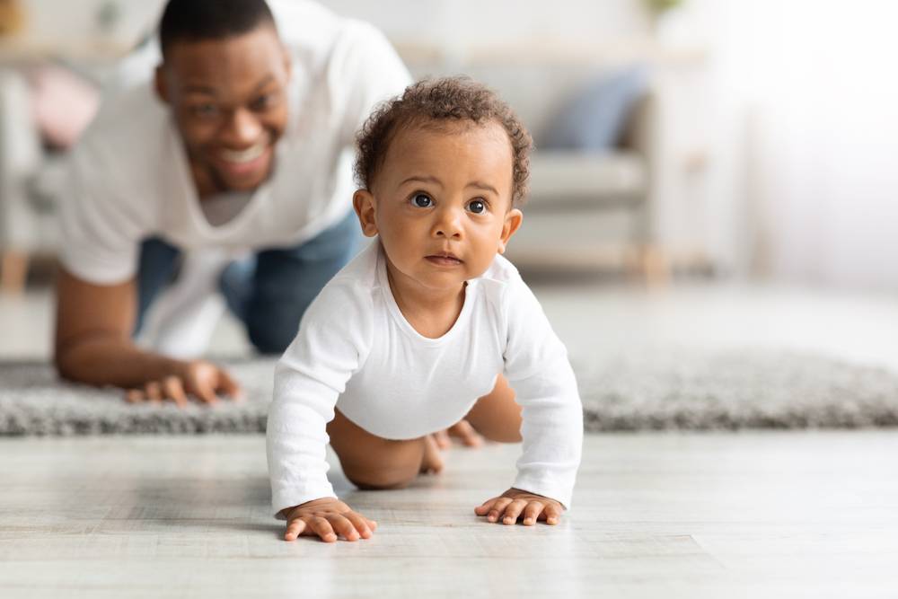 Happy,Black,Father,Looking,At,Adorable,Infant,Baby,Crawling,On